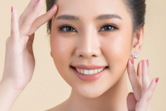 Beautiful woman face. Hand of make-up