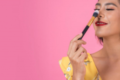 Portrait of woman with makeup brush professional show